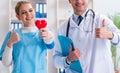 Cardiologist with his nurse assistant posing in hospital