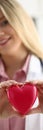 Cardiologist holds red heart in hands closeup