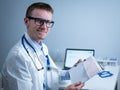 Cardiologist reading an ECG print-out. Doctor analyzing electrocardiogram. Practitioner examine patient test results