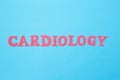 Cardiology word in red letters on a blue background. Concept of medicine section dealing with the treatment of heart diseases.