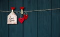 Cards with Desires Love Valentine`s card `Love You` natural cord and red pins hanging on rustic black texture background, Copy Spa Royalty Free Stock Photo