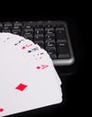 Cards beside the keyboard. online card games concept Royalty Free Stock Photo