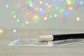 Cards with a magician wand and an out of focus light background