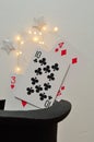 Cards in a magicians hat with silver stars