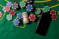 Cards, phone, casino chips and dice close up. Computer keyboard and smartphone, illuminated with pink light. Concept of Royalty Free Stock Photo