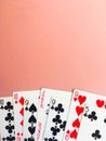 Cards for playing poker lie at the bottom of a pink background. Place for text. Royalty Free Stock Photo