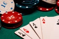 Cards with a square of aces in poker on the background of gaming chips on the green table Royalty Free Stock Photo