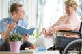 Care assistant reading book Royalty Free Stock Photo