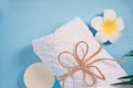 Care, beauty and spa concept. Organic soap, white towel, plumeria frangipani flower. Copy space. Top view