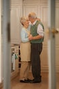 Care for a dance. Full-length shot of an elderly couple standing together in their home. Royalty Free Stock Photo