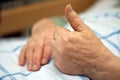 Care-dependent person showing thumbs up