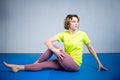 Care of flexibility. Woman practicing yoga on the floor. Stretching exercise. Fitness and body care. Physical therapy. Yoga class