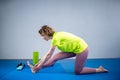 Care of flexibility. Woman practicing yoga on the floor. Stretching exercise. Fitness and body care. Physical therapy. Yoga class