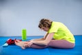 Care of flexibility. Woman practicing yoga on the floor. Stretching exercise. Fitness and body care. Physical therapy. Yoga class