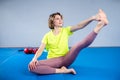 Care of flexibility. Woman practicing yoga on the floor. Stretching exercise. Fitness and body care. Physical therapy. Yoga class