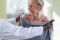 Care giver or nurse assisting elderly woman for showerand drying her Royalty Free Stock Photo