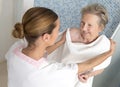 Care giver or nurse assisting elderly woman for shower Royalty Free Stock Photo