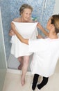 Care giver or nurse assisting elderly woman for shower Royalty Free Stock Photo