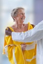 Care giver or nurse assisting elderly woman for showerand drying her Royalty Free Stock Photo