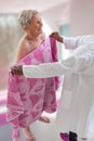 Care giver or nurse assisting elderly woman for showerand drying her Royalty Free Stock Photo