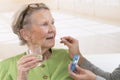 Care giver or nurse giving to elderly woman her pills Royalty Free Stock Photo