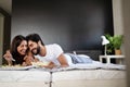 Happy young couple have breakfast at the bed. Care and romance at the morning. Royalty Free Stock Photo