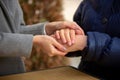 Close-up of young female hands holding senior woman hands Royalty Free Stock Photo