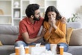 Care And Support. Loving Indian Man Caring About Ill Wife Suffering Flu Royalty Free Stock Photo