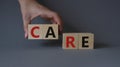 Care symbol. Concept word Care on wooden cubes. Businessman hand. Beautiful grey background. Business and Care concept. Copy space Royalty Free Stock Photo