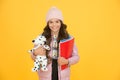 Care and treatment of animals. Studying veterinary medicine. Happy child hold toy dog and books. Little girl smile with Royalty Free Stock Photo