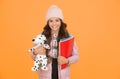 Care and treatment of animals. Studying veterinary medicine. Happy child hold toy dog and books. Little girl smile with Royalty Free Stock Photo