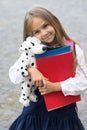 Care and trust. Preschool child hug toy dog. Back to school supplies. Preschool education. Afterschool care. Daycare and Royalty Free Stock Photo