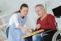 Care worker giving older man dinner Royalty Free Stock Photo