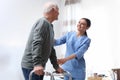 Care worker helping elderly man with walker in hospice Royalty Free Stock Photo