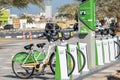 Careem eco-friendly green bike rentals in a row at the RAK Corniche for exercise and fu Royalty Free Stock Photo