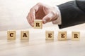 Career adviser assembling the word career with six wooden cubes Royalty Free Stock Photo