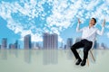 Career business man sitting chair Express feeling In gray room and sky with city blurry background Metaphor for Success finance De Royalty Free Stock Photo