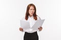 Career, business and women concept. Portrait of concerned and anxious office lady panicking as reading documents Royalty Free Stock Photo