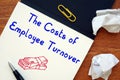 Career concept meaning The Costs of Employee Turnover with sign on the page