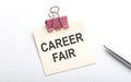 CAREER FAIR text on the sticker with pen on white background