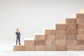 Career ladder. Steps up as symbol of the path to the goal. Man in suit stands at the beginning of the path to successful