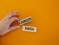 Career path symbol. Concept word Career path on wooden blocks. Businessman hand. Beautiful orange background. Business and Career Royalty Free Stock Photo