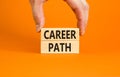 Career path symbol. Concept words Career path on wooden blocks on a beautiful orange table orange background. Businessman hand. Royalty Free Stock Photo