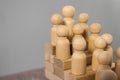 Career stair concept. Wooden people figures as employers on stair made of wooden cubes on gray background Royalty Free Stock Photo