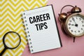 Career Tips text written on notepad with alarm clock and magnifying glass Royalty Free Stock Photo