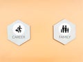 Career versus family concept. Wooden hexagon with icons against dark yellow background.