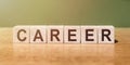 CAREER word written on wooden blocks on wooden table. Concept for your design