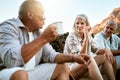 Carefree, adventure and exploring friends talking, bonding and enjoying relaxing outdoors. Senior group enjoying a break