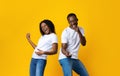 Carefree african american couple having fun on yellow Royalty Free Stock Photo