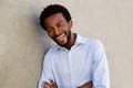 Carefree african american man laughing with arms crossed